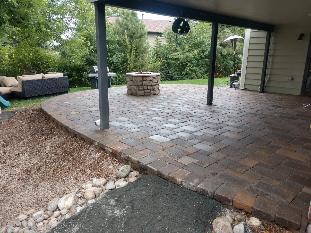 A patio with a fire pit under a covered patio.