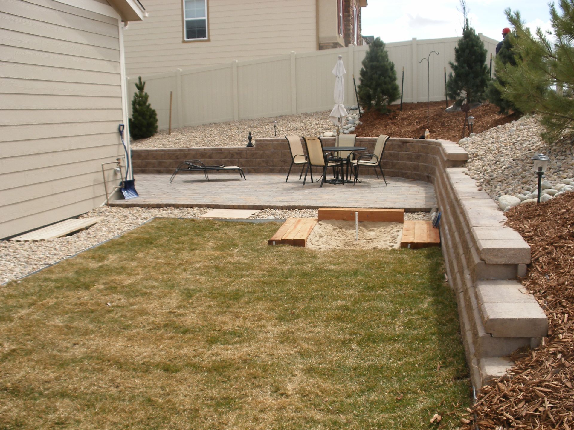 A backyard with a table and chairs in it