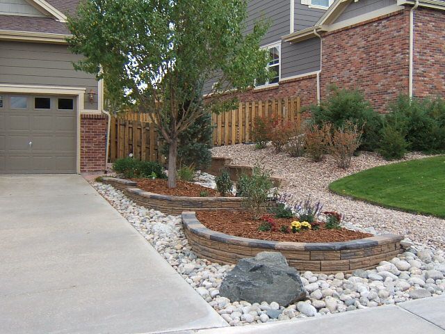 A house with a driveway and a brick fence