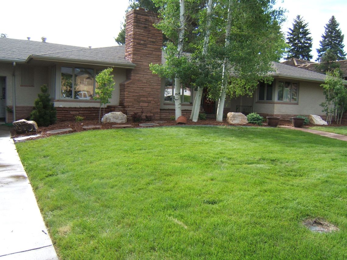 A house with a large lawn in front of it