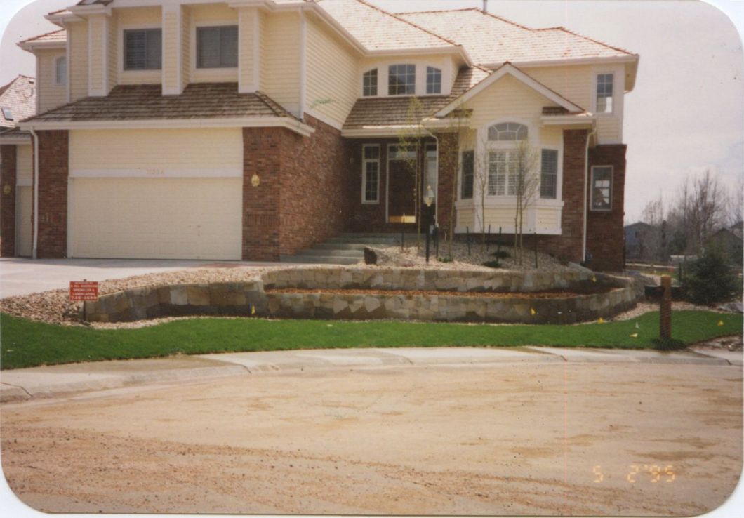 A large house with a brick facade and a white garage door