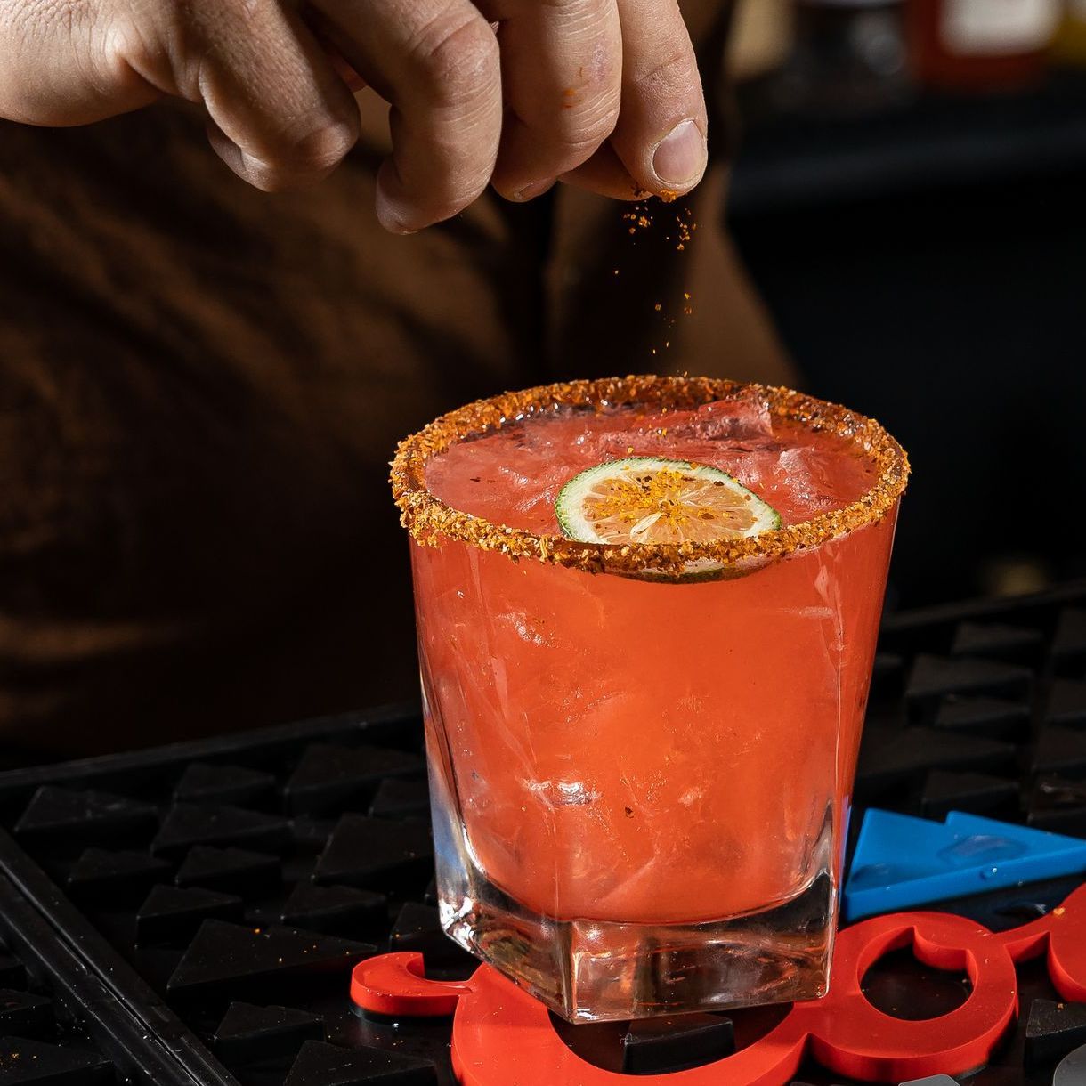 pink margarita with a sliced lime made at tony tenderonis in denver near coors field