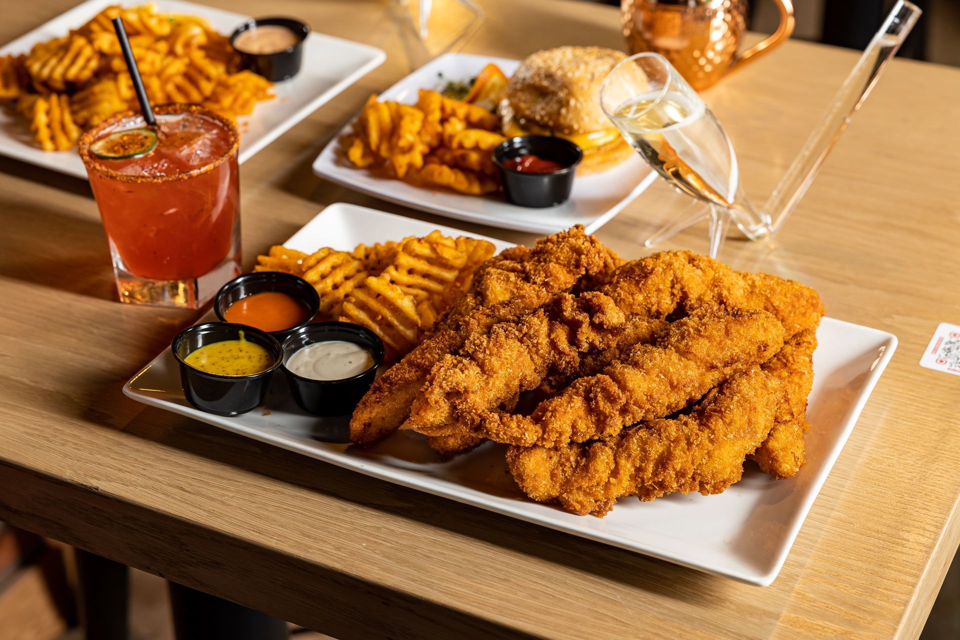 Chicken tenders plate with waffle fries and a margarita from Tony Tenderonis in Denver Colorado near Coors Field