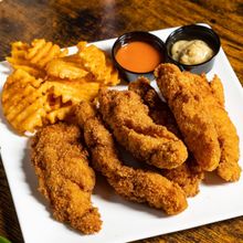 Chicken tenders plate with waffle fries from Tony Tenderonis in Denver Colorado near Coors Field