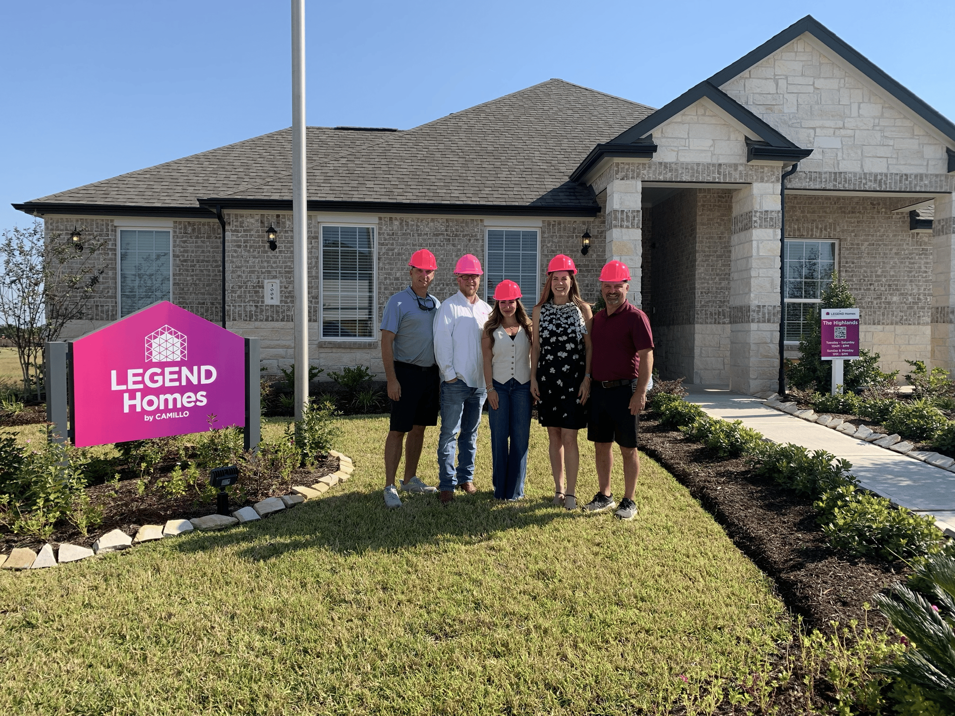 Legend Homes team members in front of model home