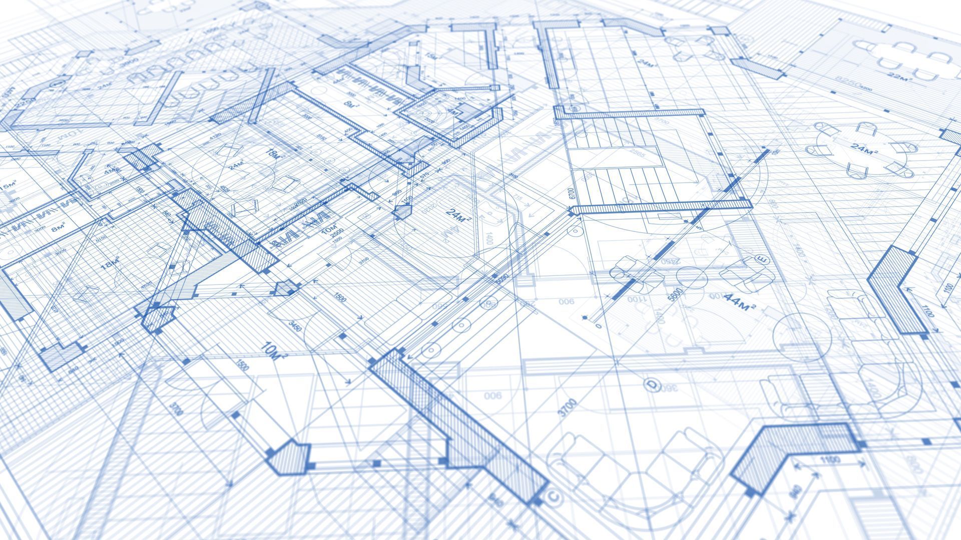 Architectural blueprints with blue lines and details, showing building plans from a top-down perspective.
