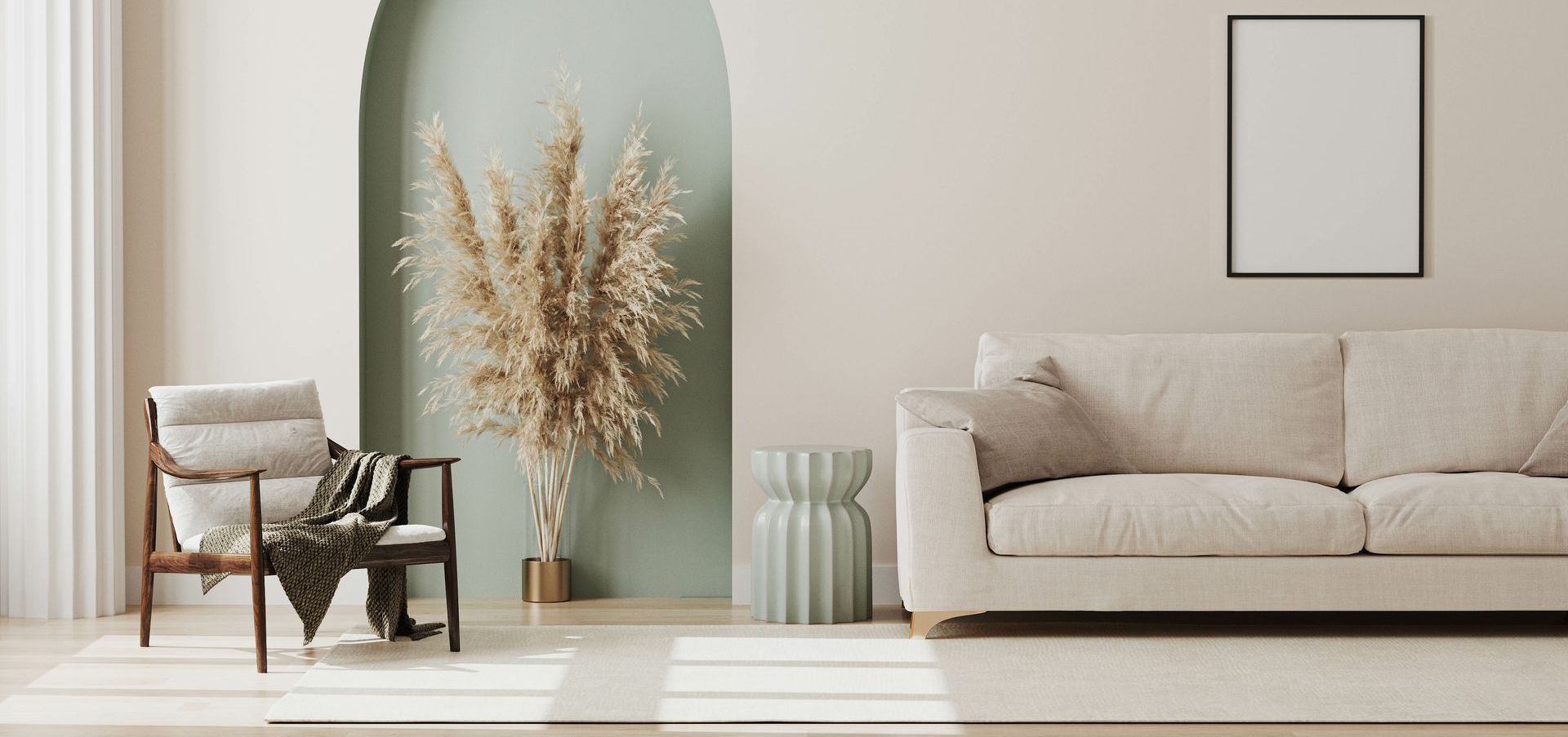 A living room with a couch , chair , and pampas grass.