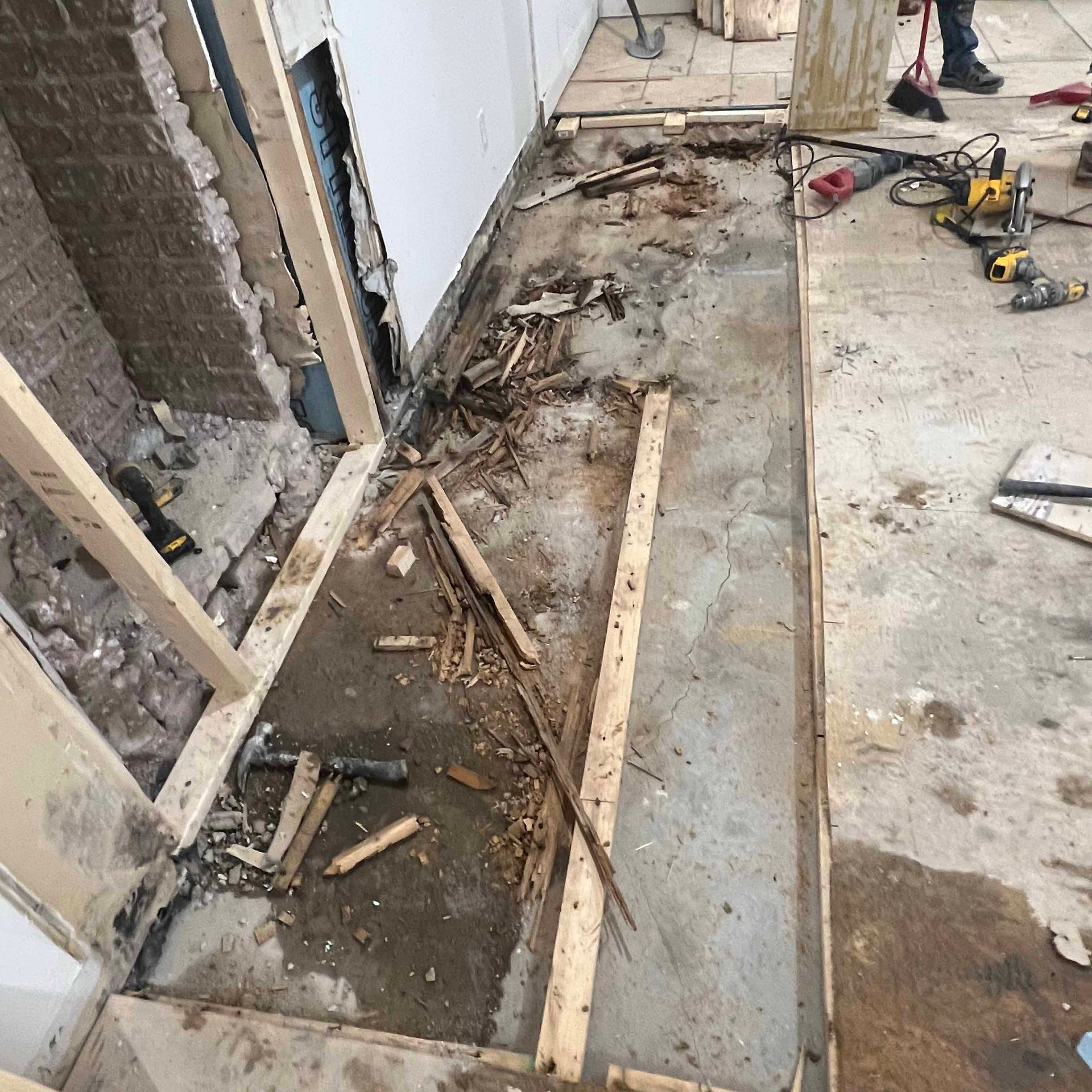 A construction site with a lot of tools on the floor