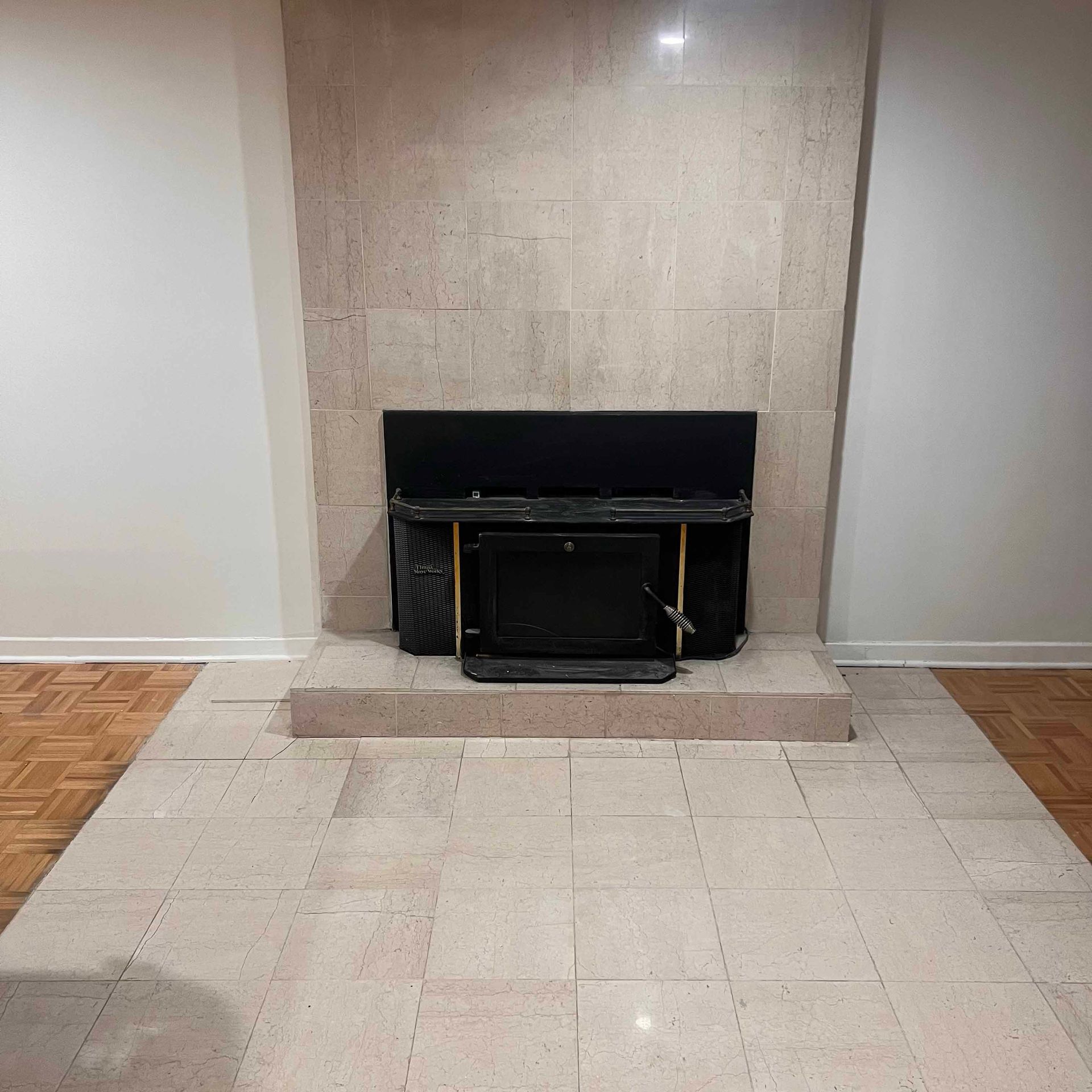 There is a fireplace in the middle of the room.