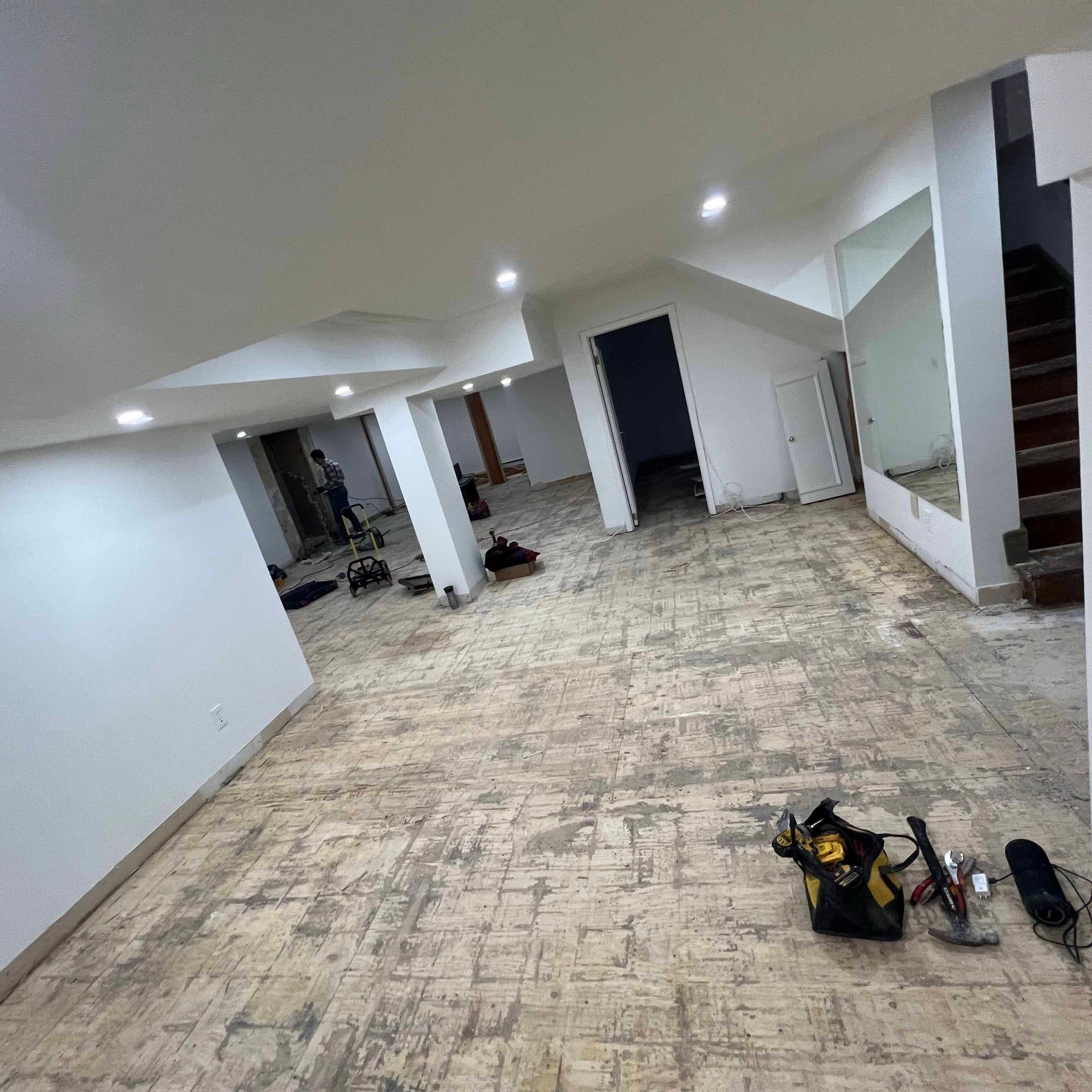 A large empty room with a lot of tools on the floor.