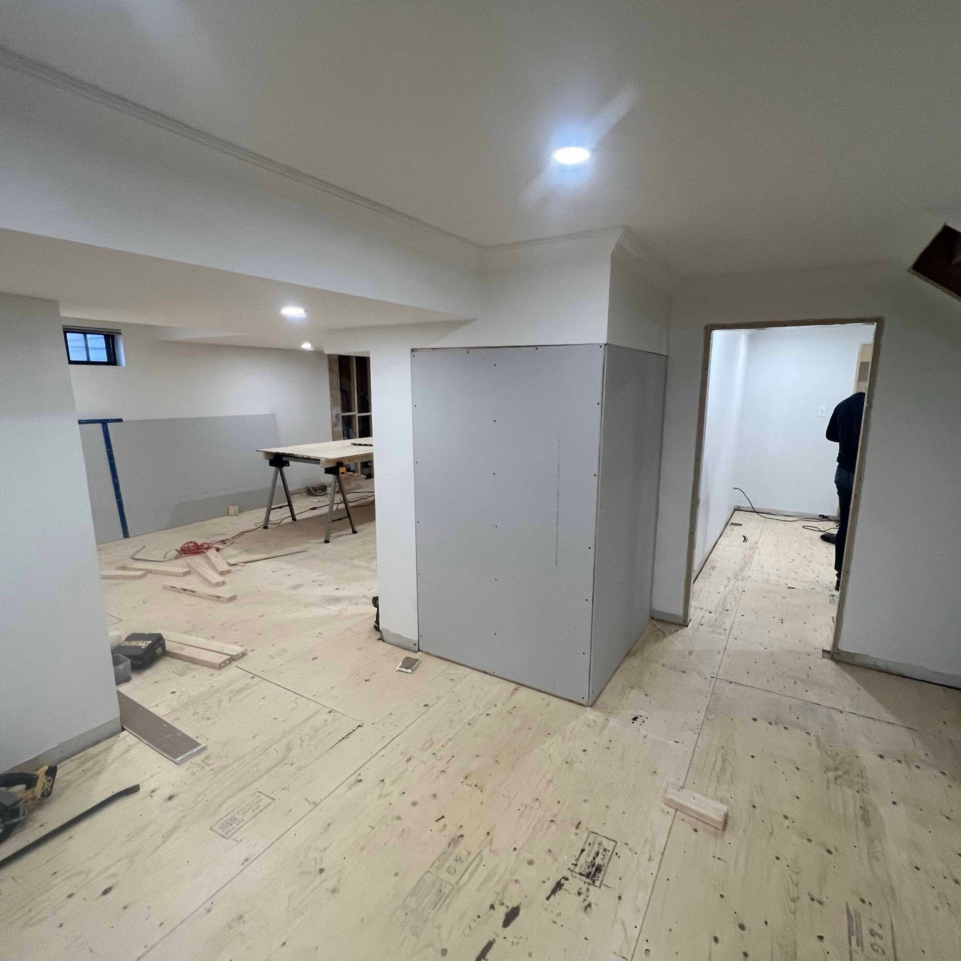 A room with a wooden floor and white walls