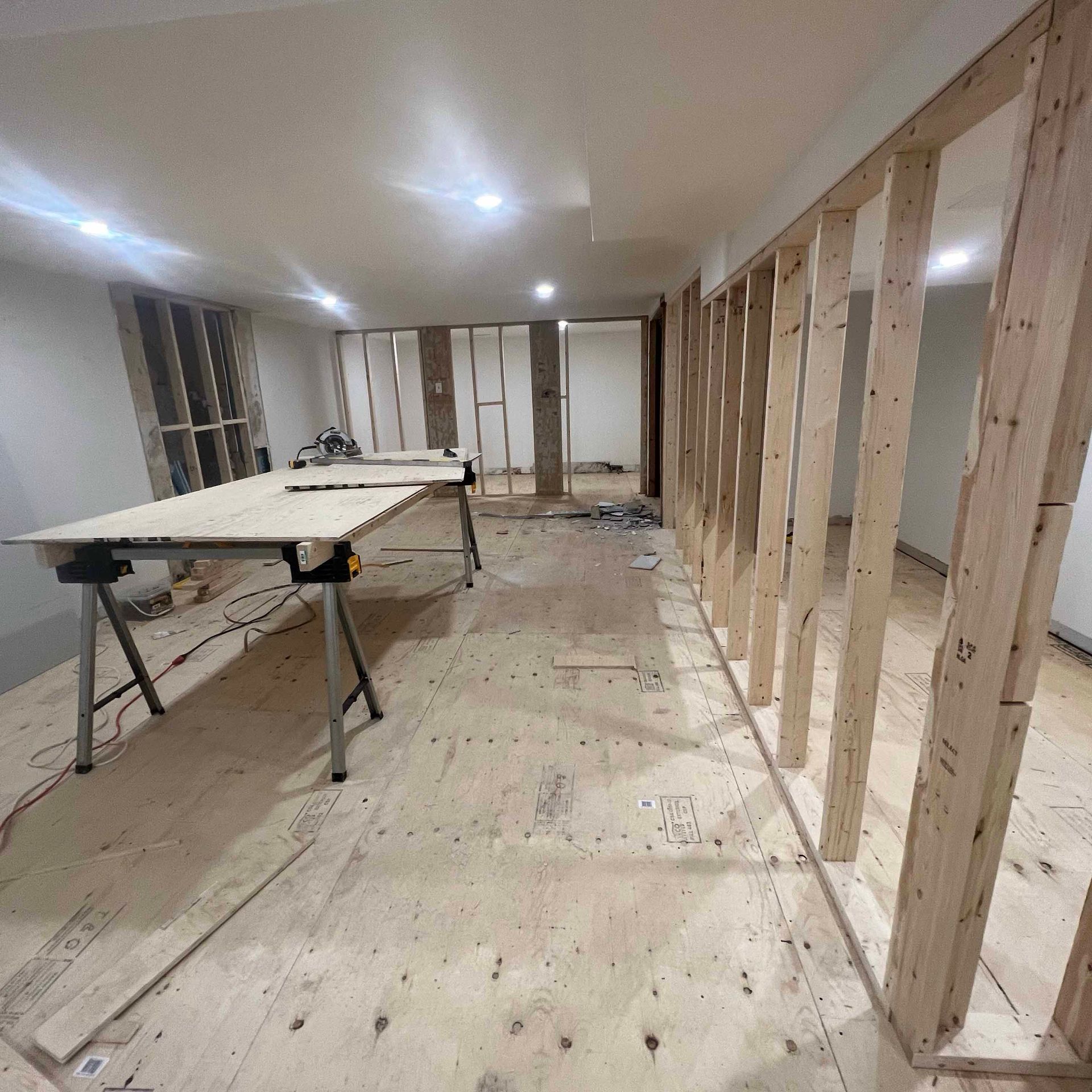 A room with wooden walls and a table in the middle of it.