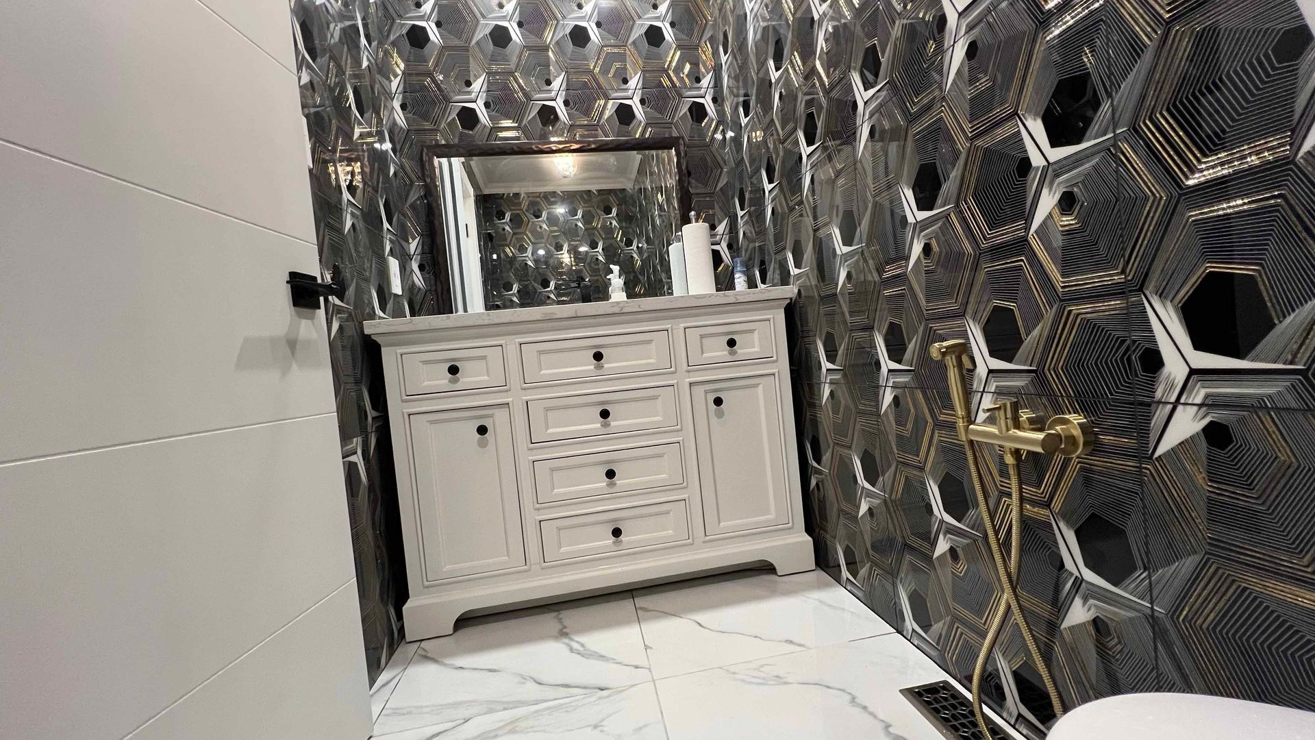 A bathroom with a sink , mirror , and toilet.