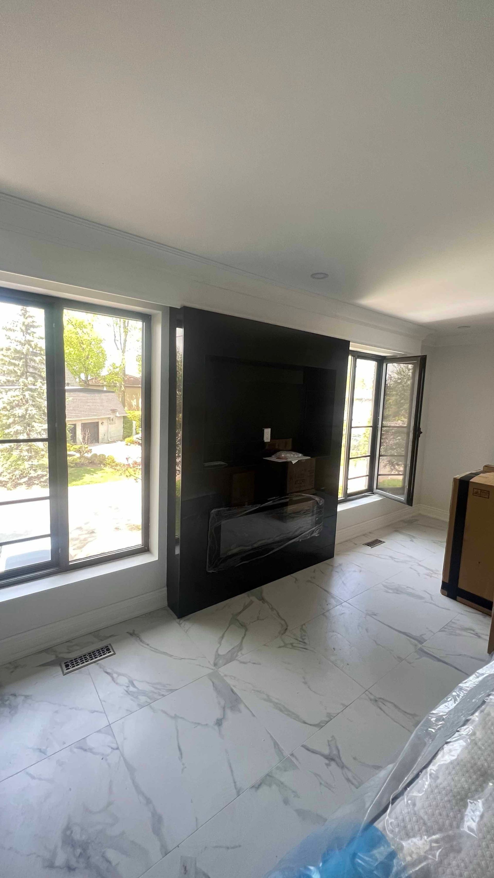A living room with a fireplace and a flat screen tv.