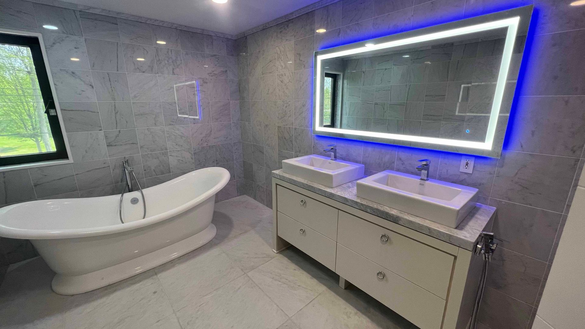 A bathroom with two sinks , a bathtub and a mirror.
