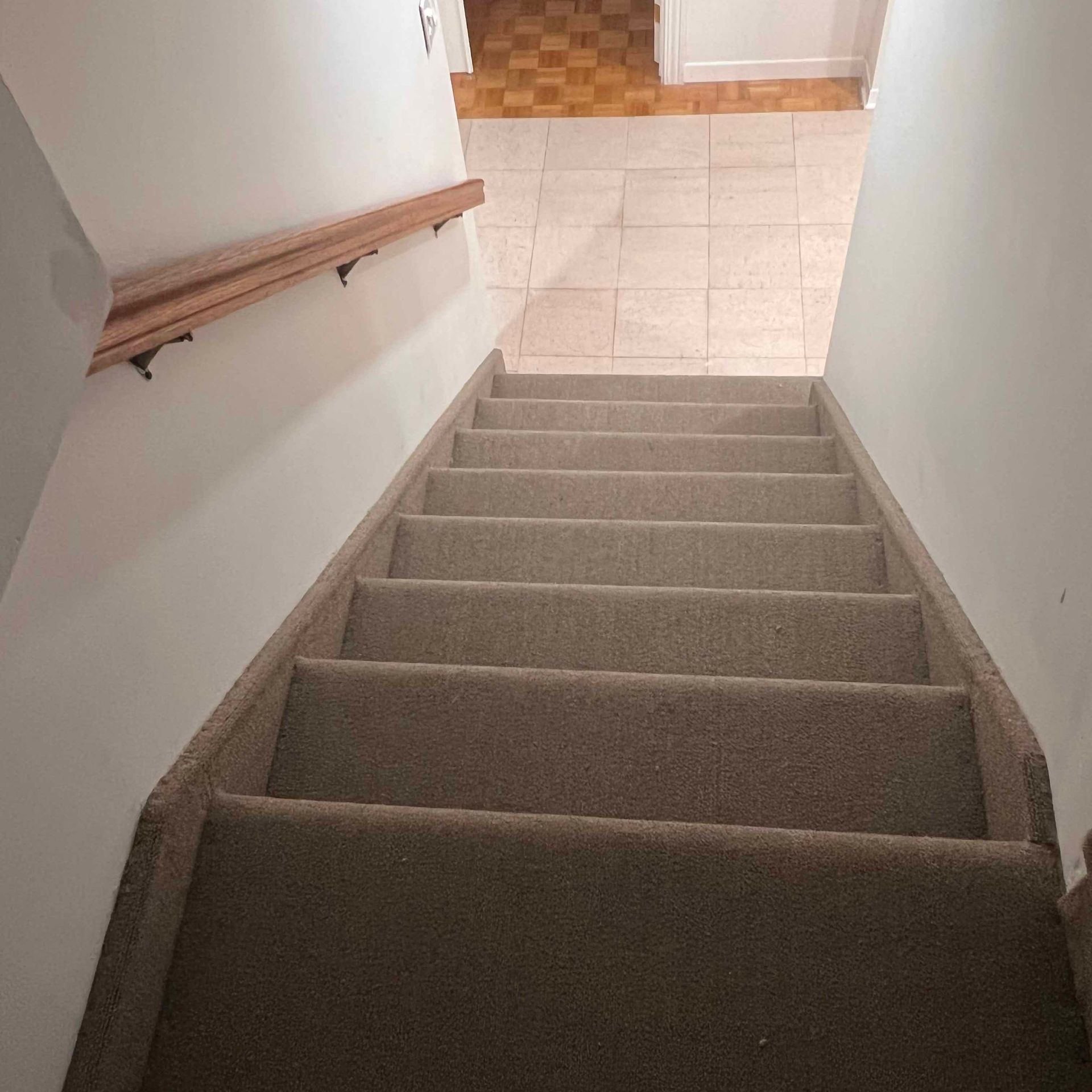 A set of stairs leading up to a tiled floor.