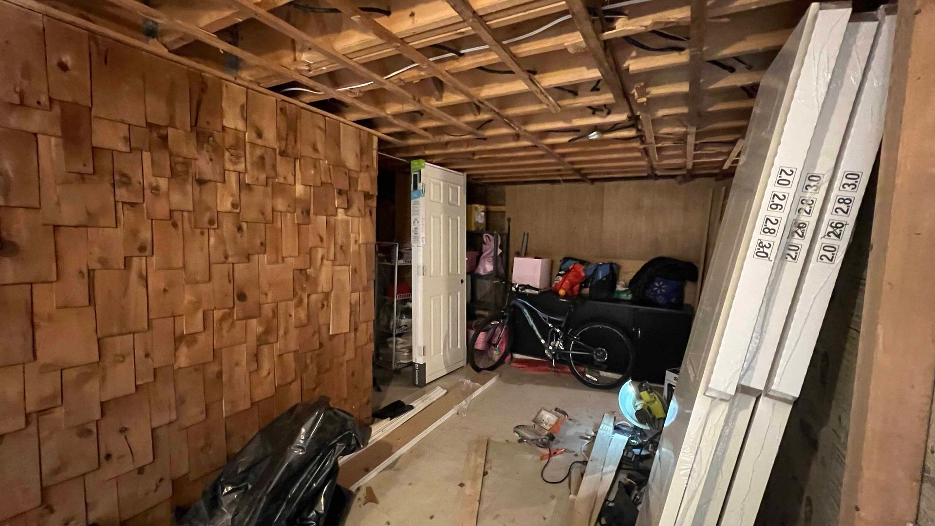 A garage filled with lots of boxes and a bicycle.