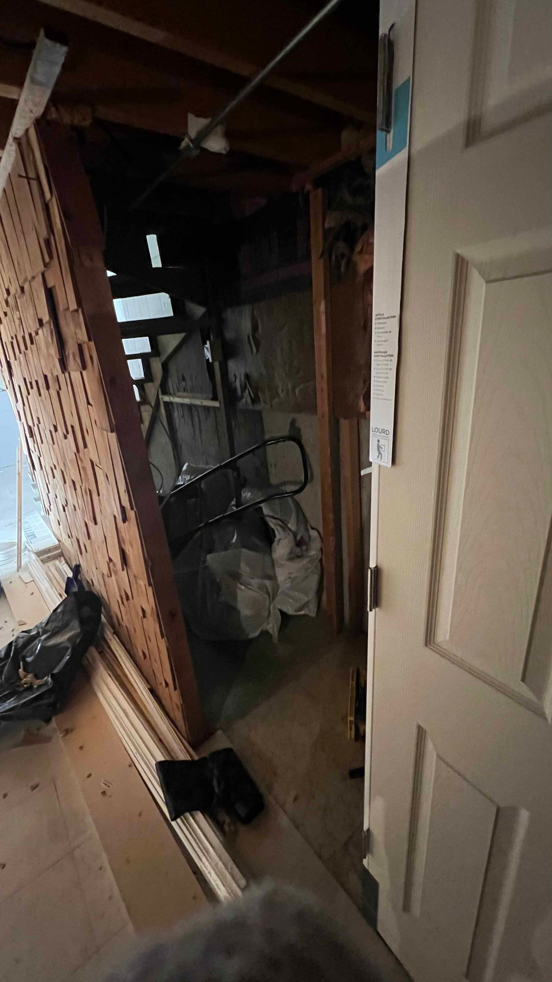 A door is open to a room with a staircase in the corner.