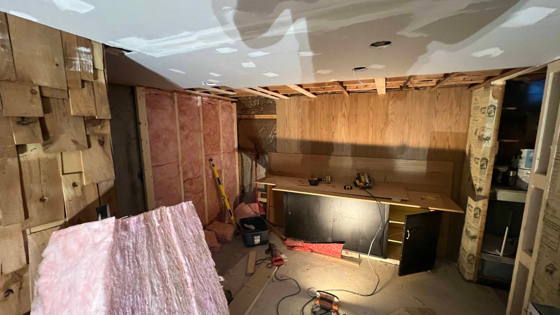 A room with a lot of wooden walls and a ceiling that is being built.