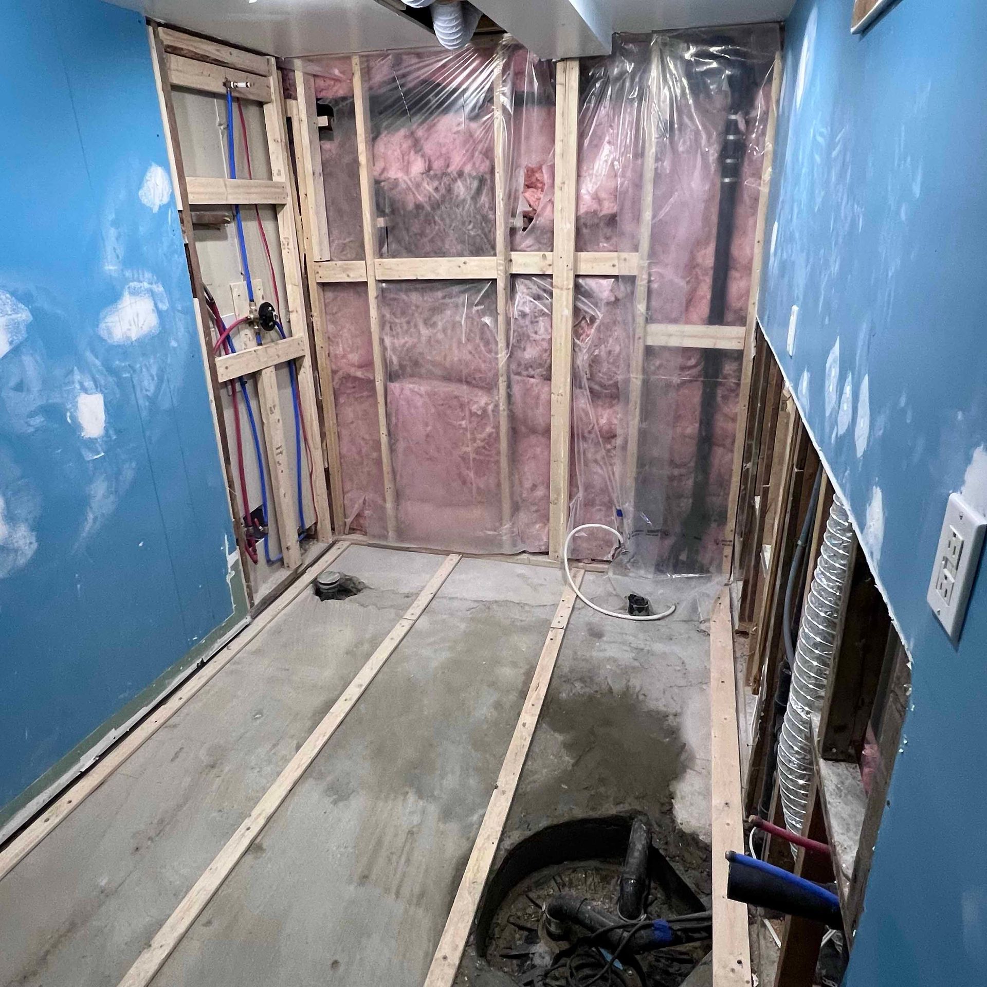 A room with a lot of wooden walls and a concrete floor.