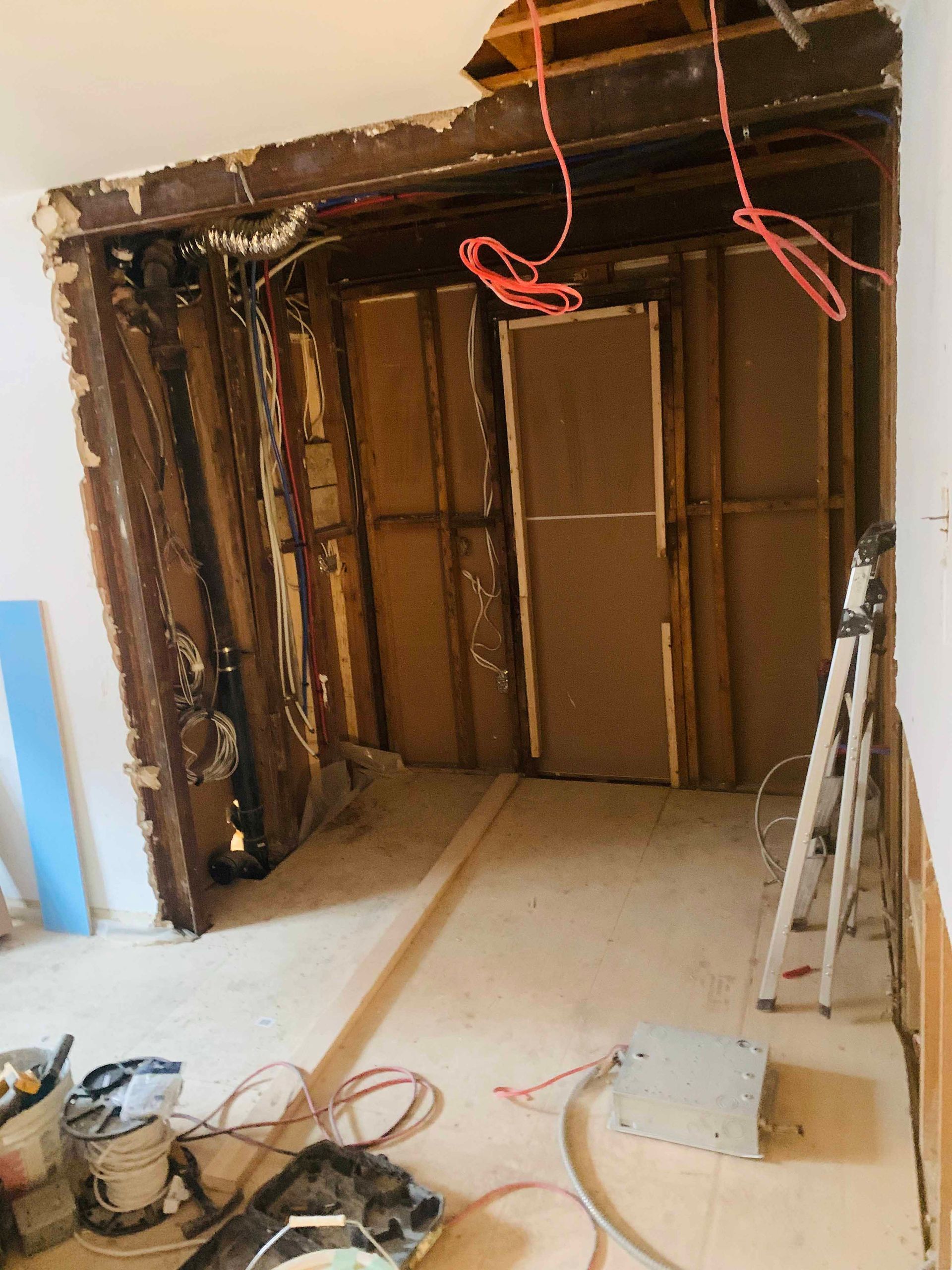 A room that is being remodeled with a ladder on the floor
