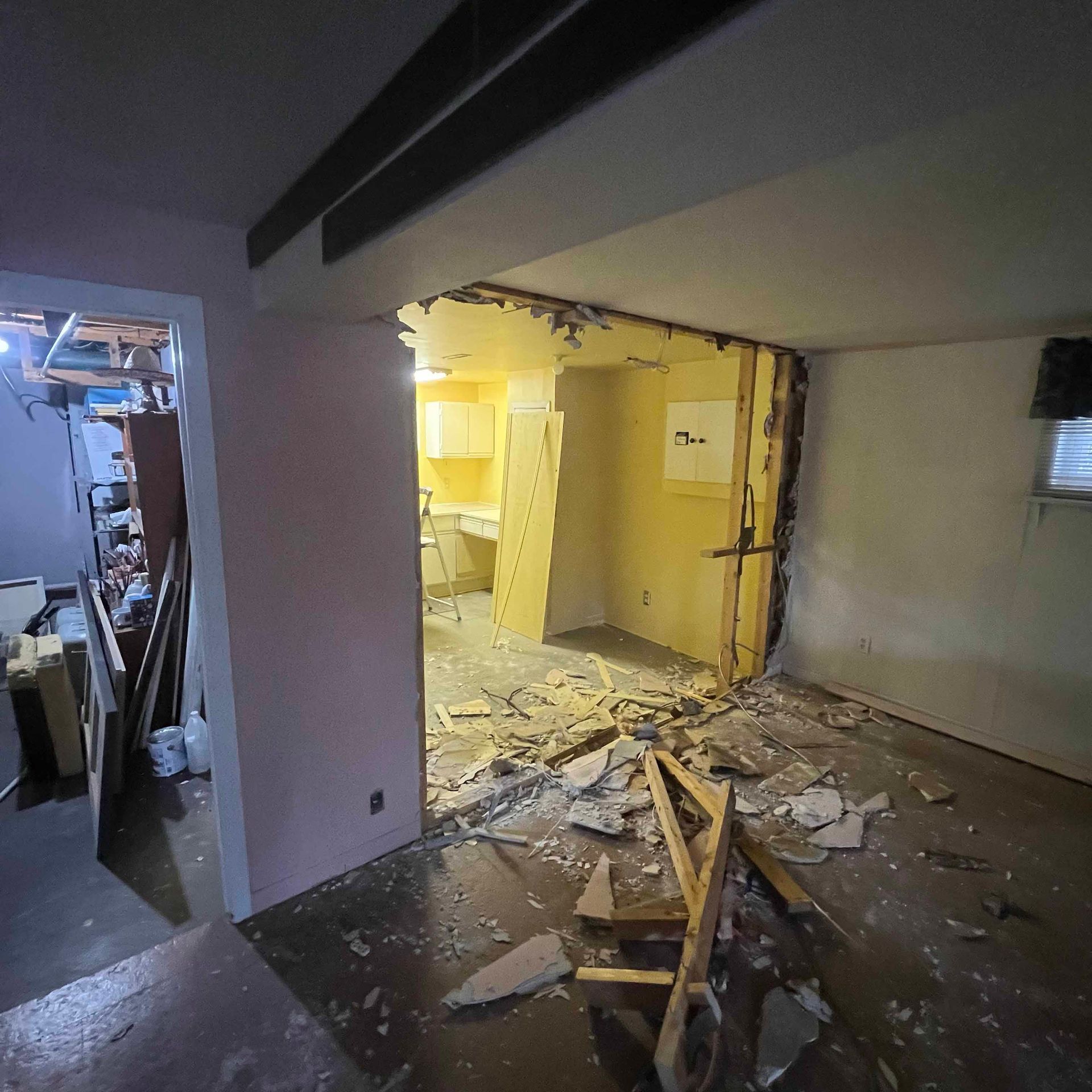 A room with a broken wall and a chair in it