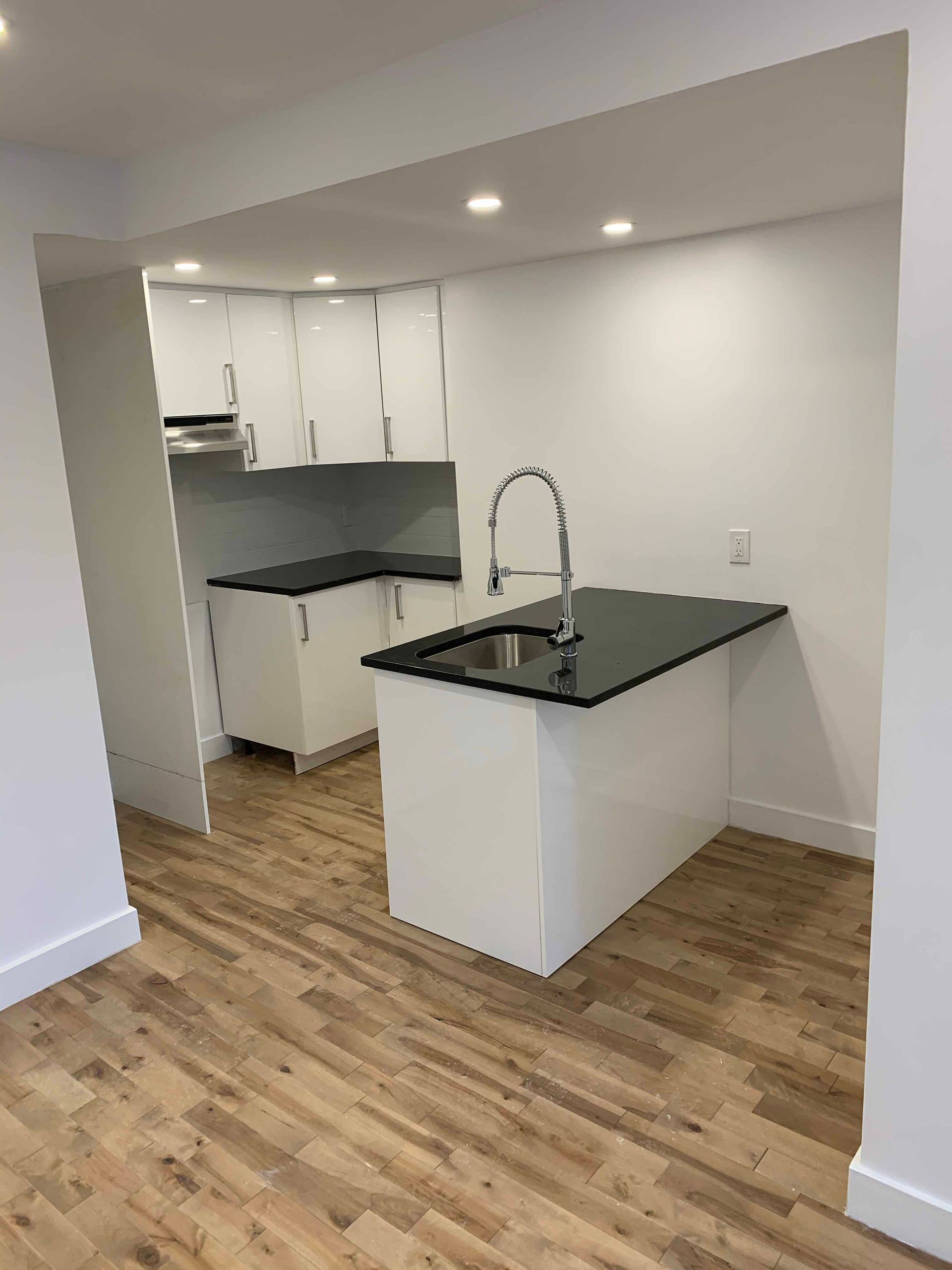 A kitchen with a large island and a sink.