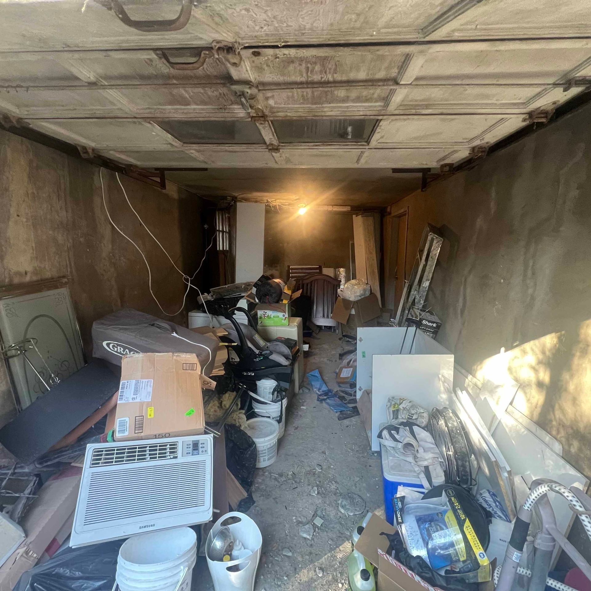 A garage filled with lots of junk and boxes.