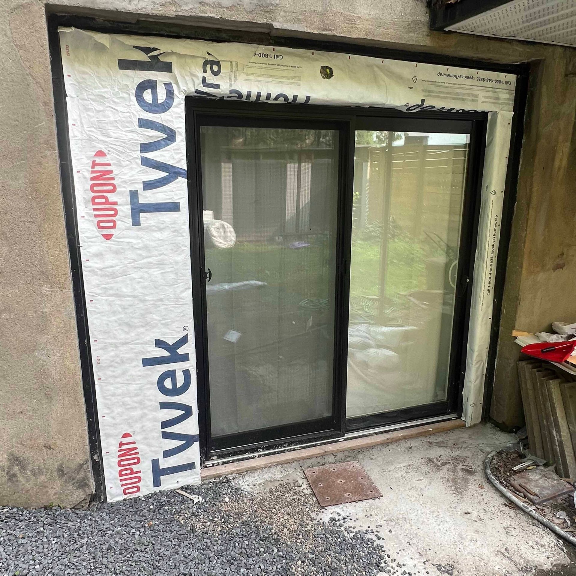 A sliding glass door is being installed in a house.