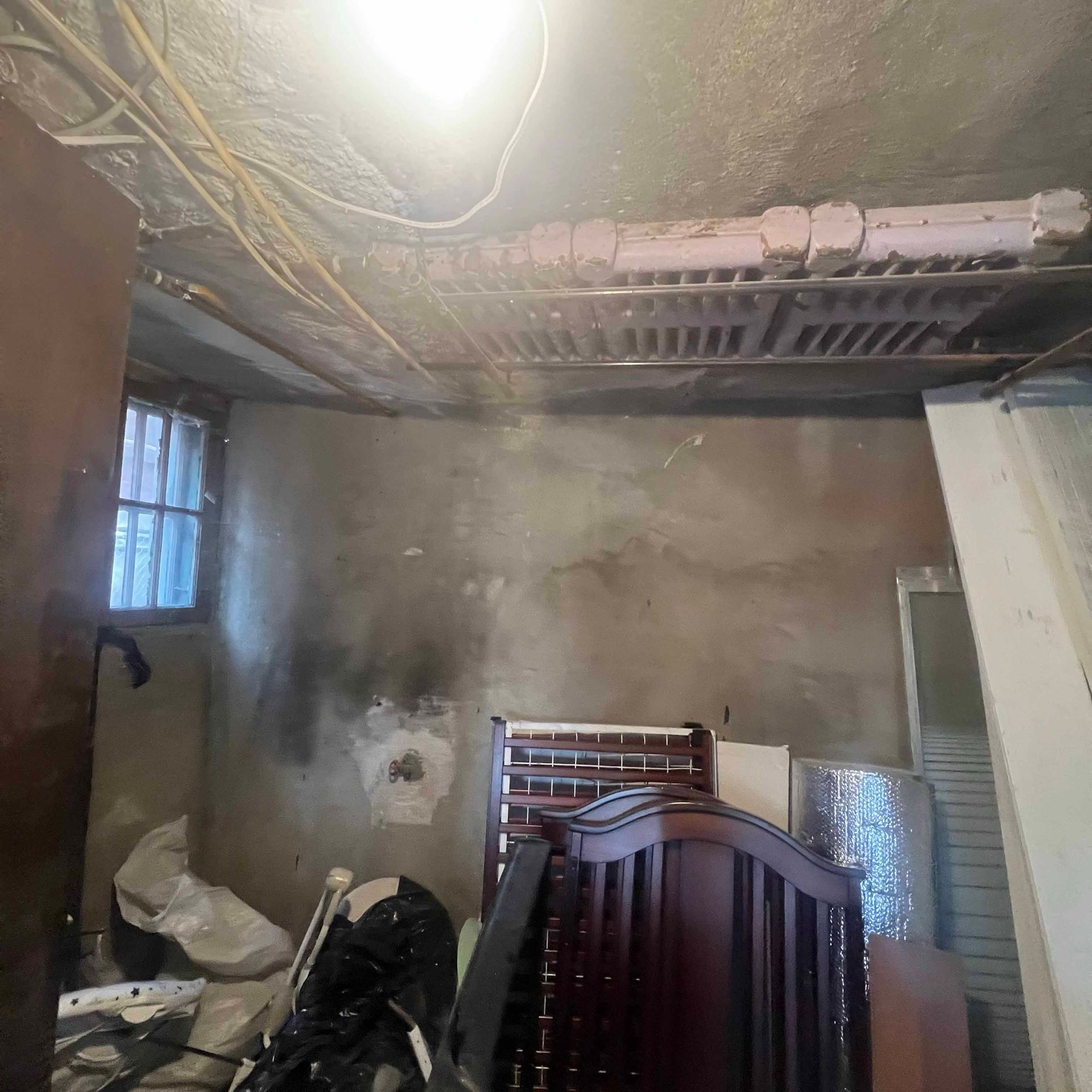 A room with a ceiling fan and a bed in it