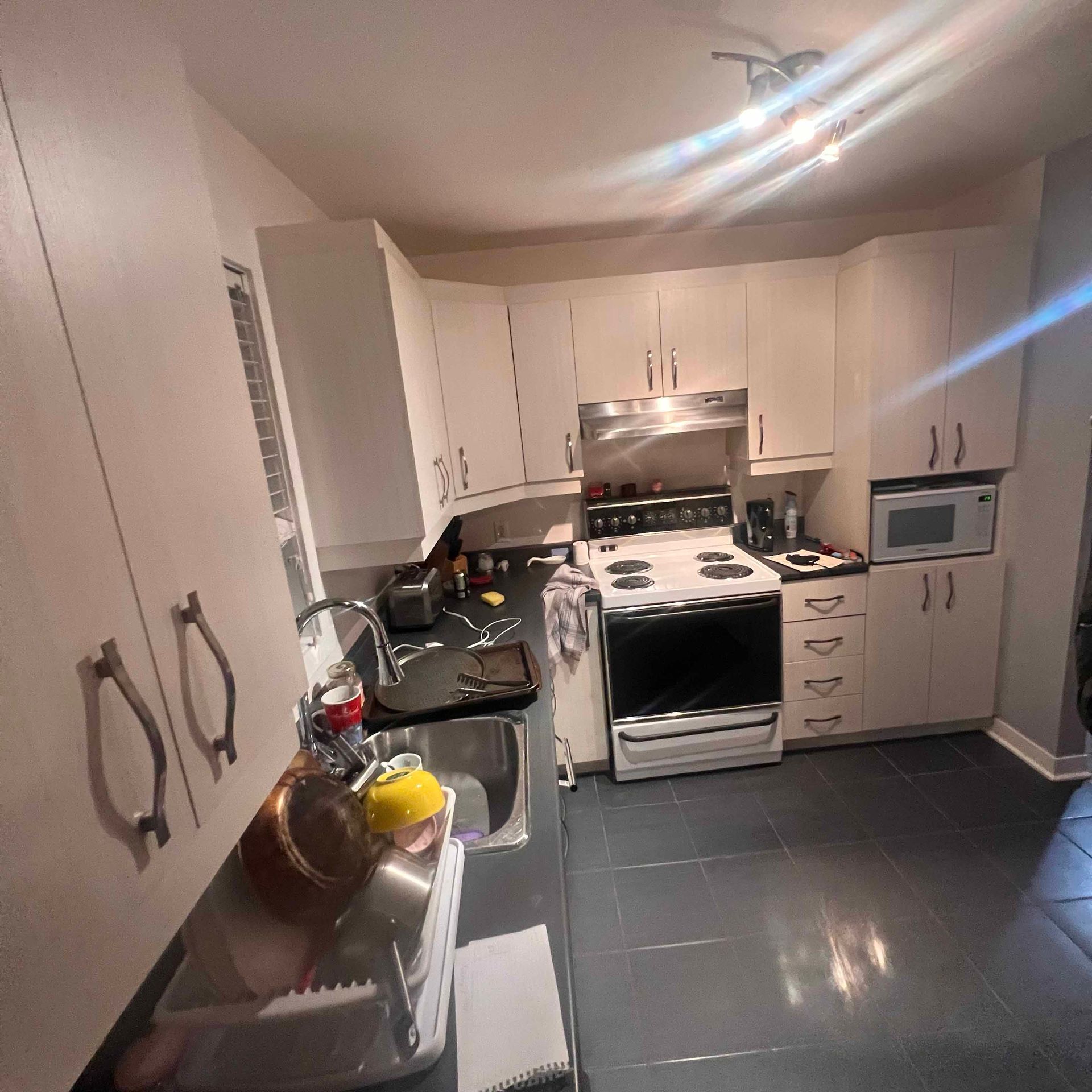 A kitchen with stainless steel appliances and white cabinets