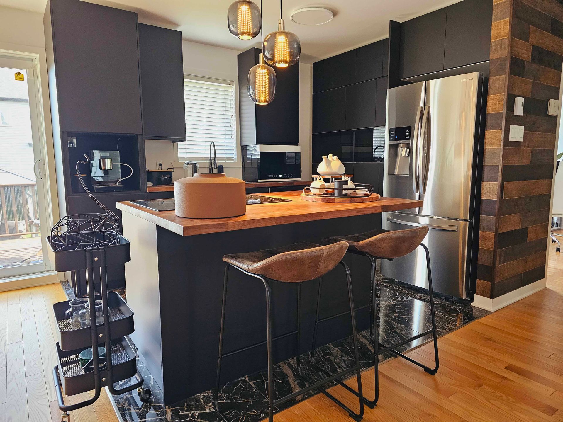 A kitchen with a large island and stools