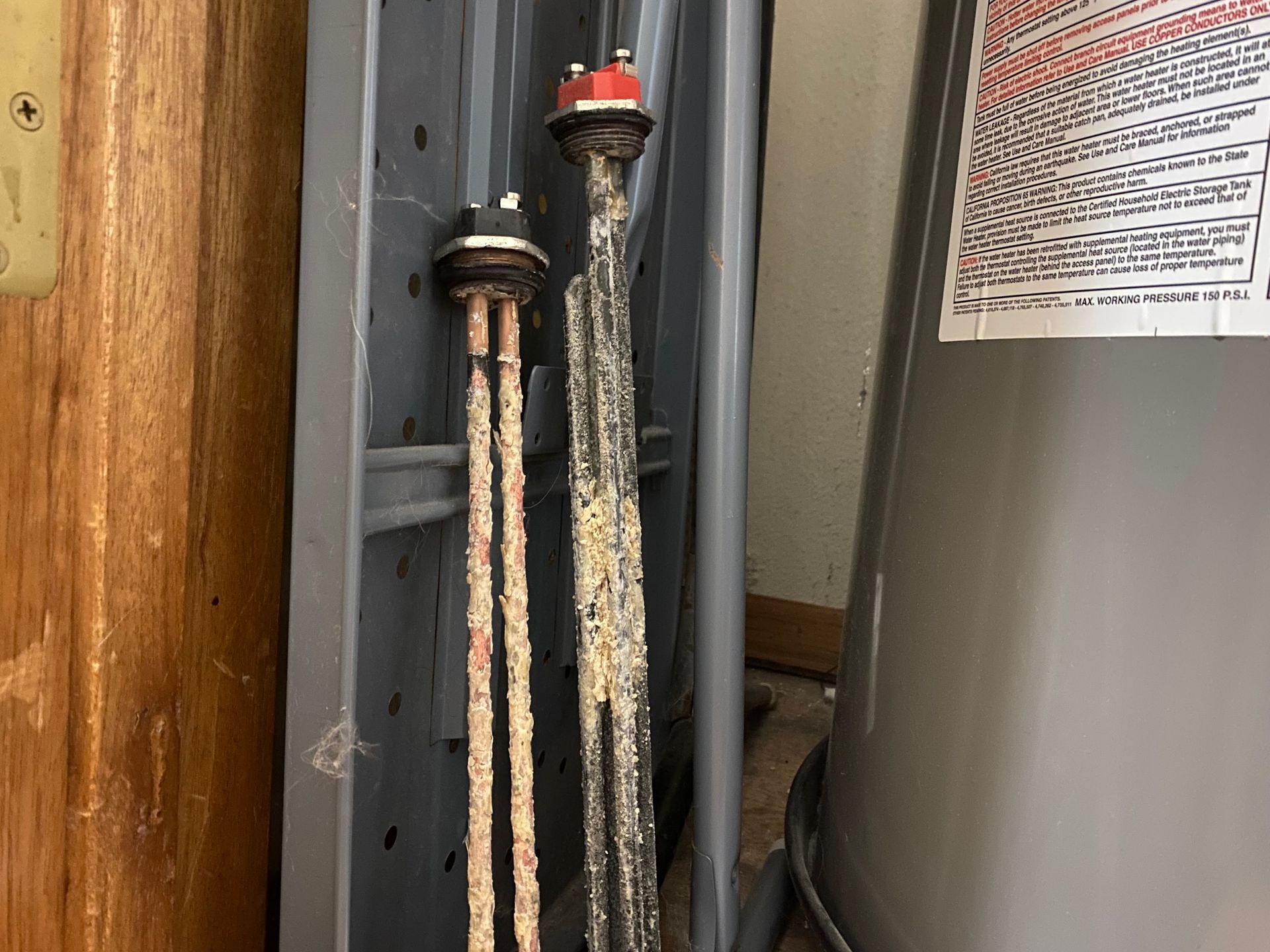 A close up of a water heater with rust on it.