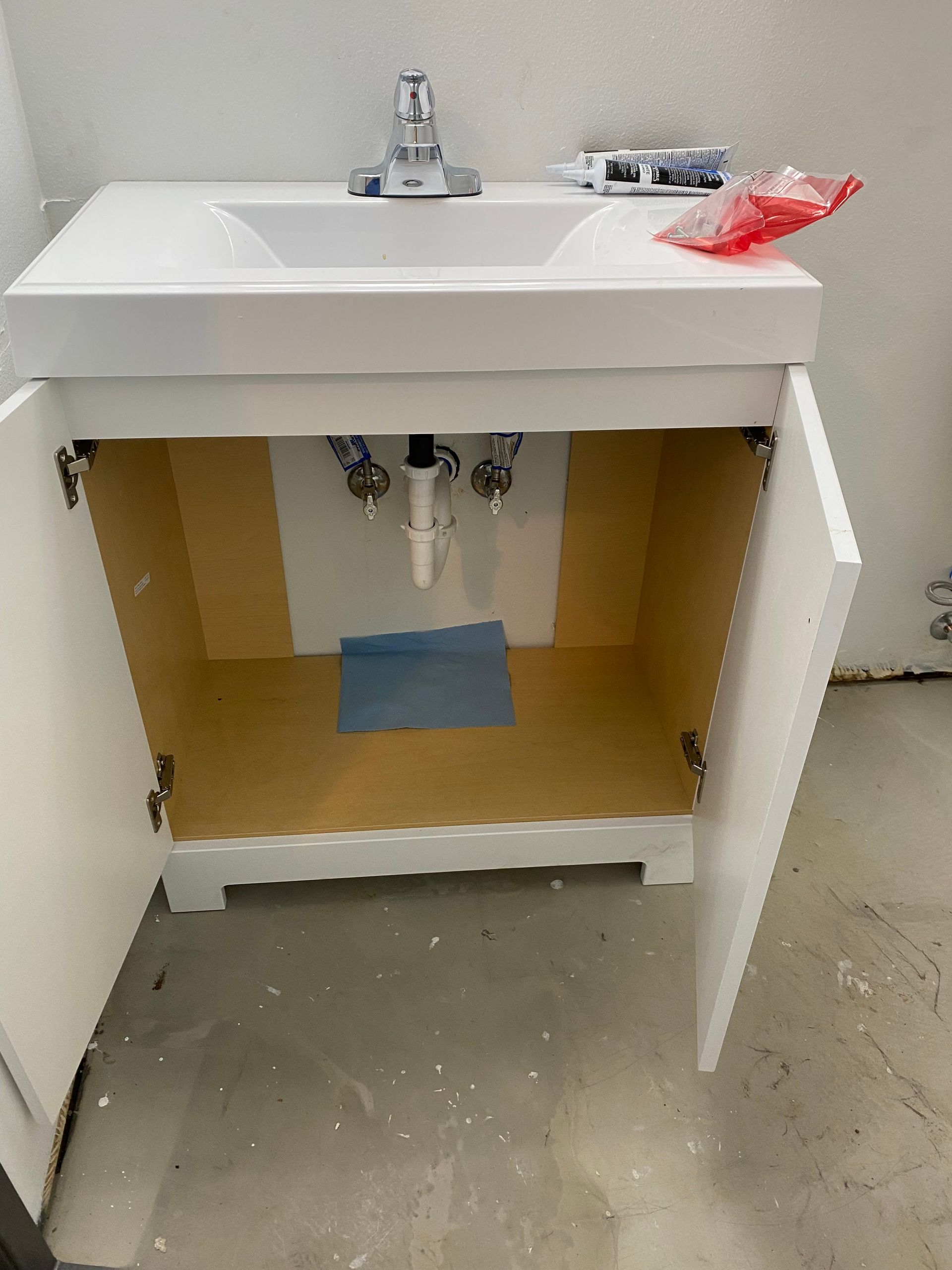 A bathroom sink with a cabinet underneath it.
