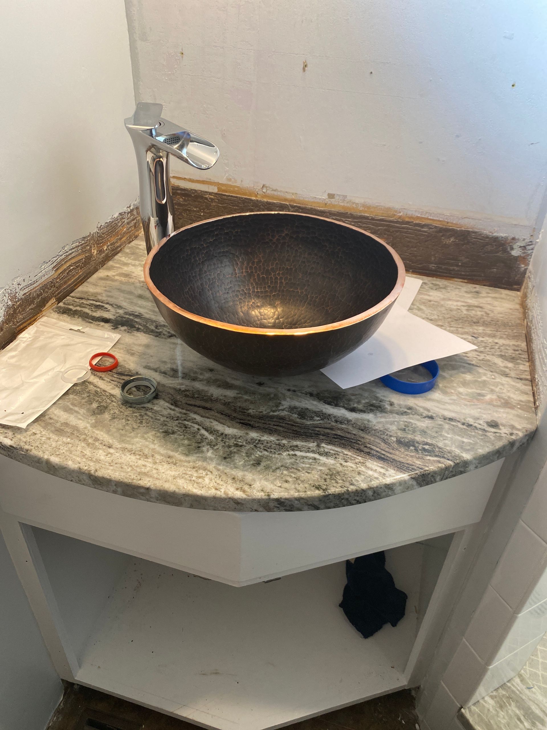A bathroom sink is sitting on top of a granite counter.