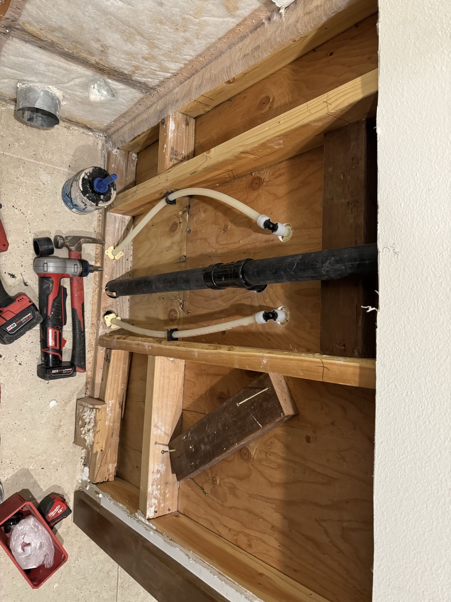 A bunch of tools are sitting on the floor in a room.