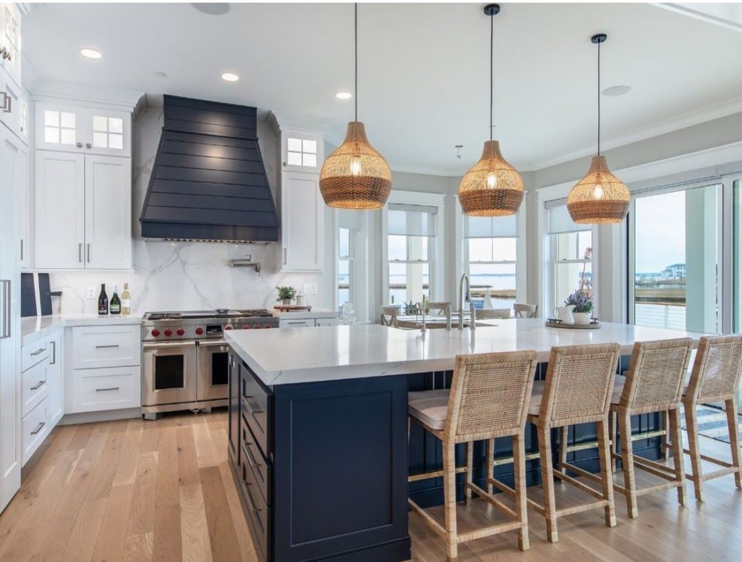 A kitchen with a table and chairs in it and a skylight above it.
