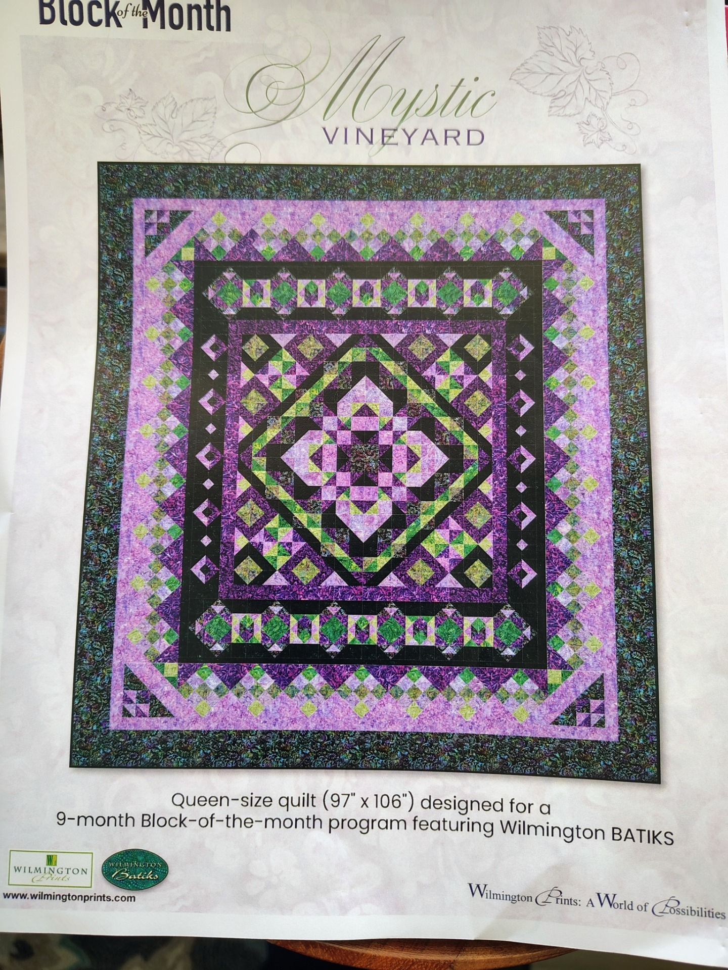Block Month quilt pattern cover with a purple, black, and green geometric quilt design.