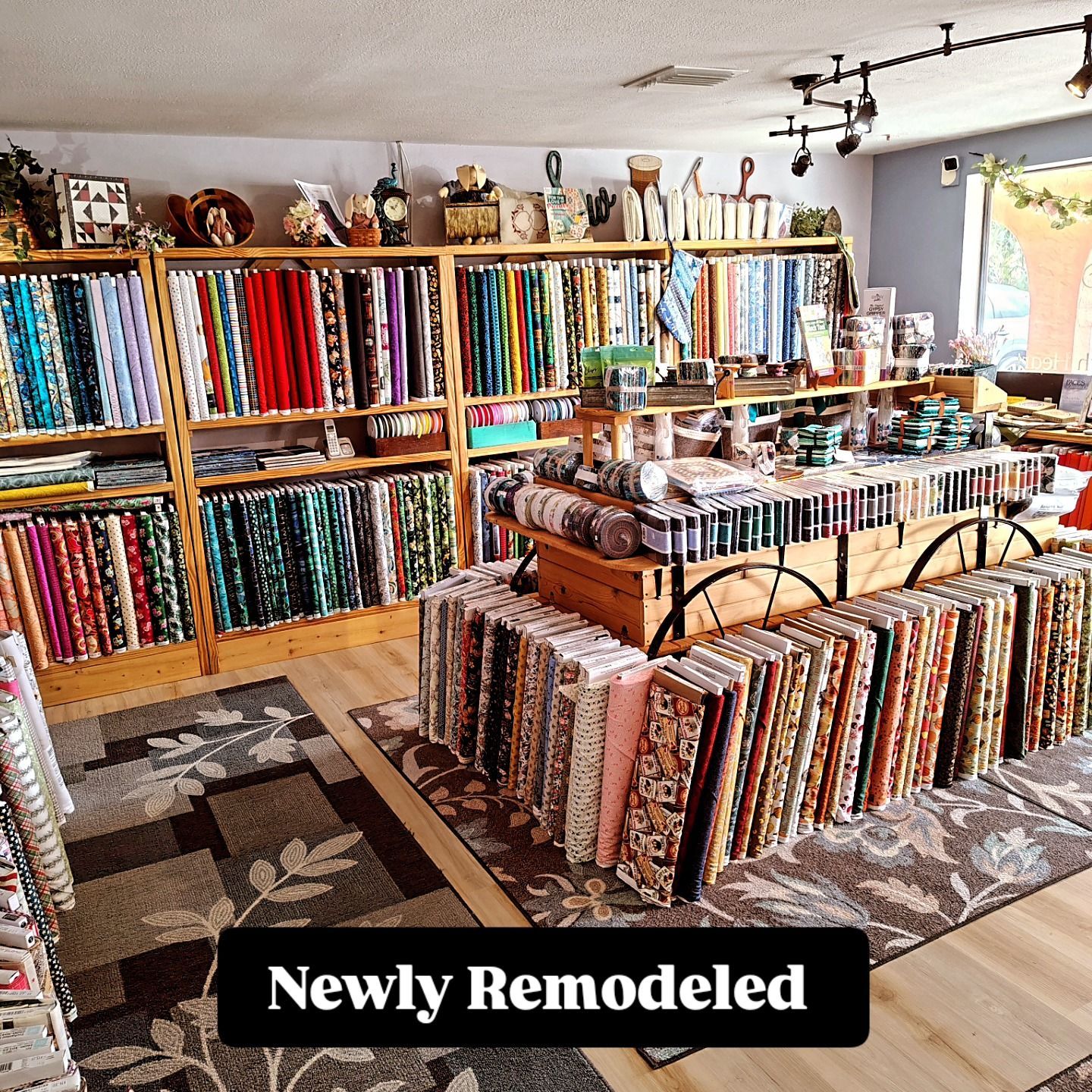 Newly remodeled quilt shop with colorful fabric bolts and display tables