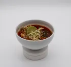 Plate of Mexican food: grilled steak, rice, refried beans with cheese, lime wedges.