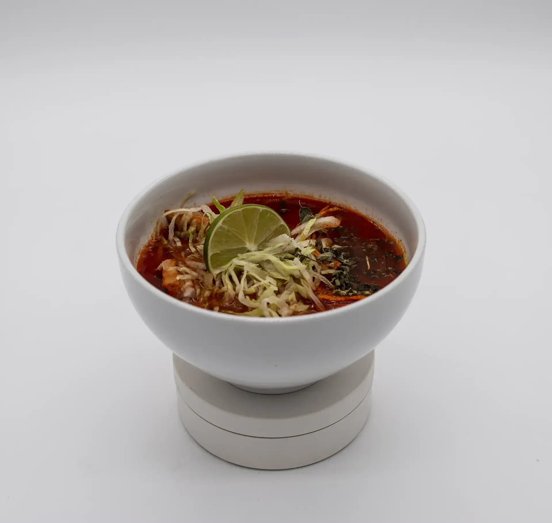 Plate of Mexican food: grilled steak, rice, refried beans with cheese, lime wedges.