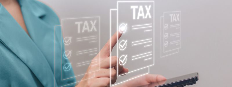 A woman is using a smart phone to check her taxes.