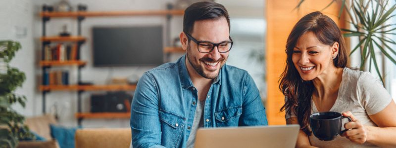 people-looking-at-computer-smiling