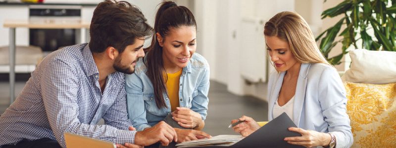 couple-going-over-documents-with-lady