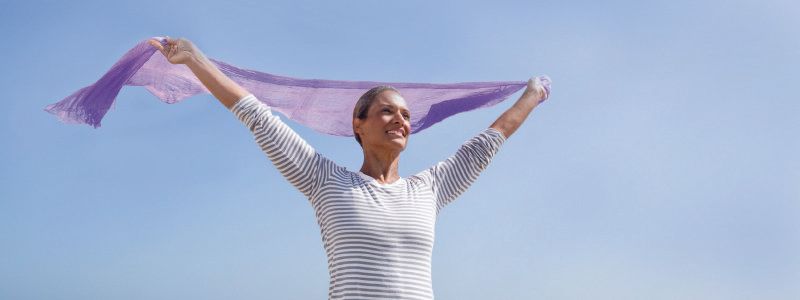 lady-standing-in-wind-with-scarf-blowing