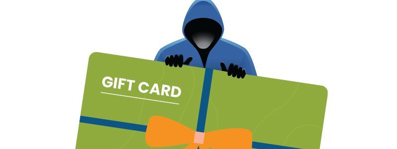 image of a person in a hoodie holding a large gift card