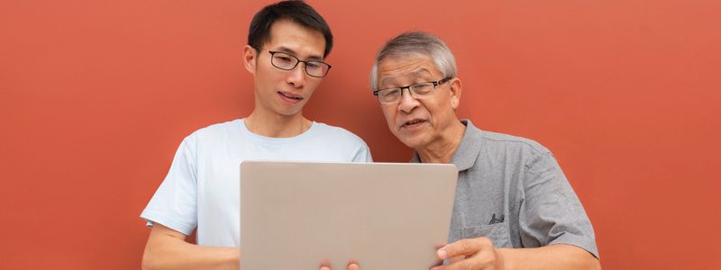 two-men-looking-at-a-laptop