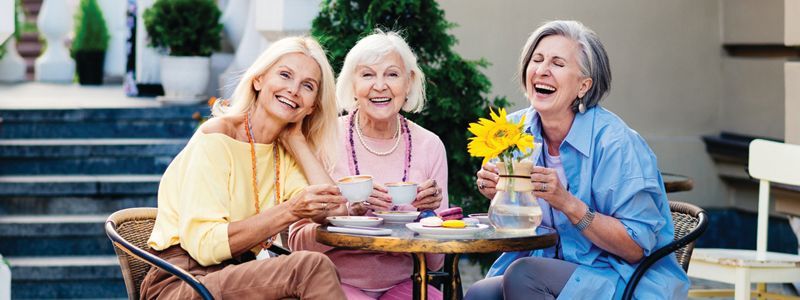 three ladies enjoying a meal together and laughing