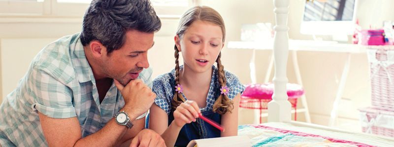 a father and daughter working on a project together