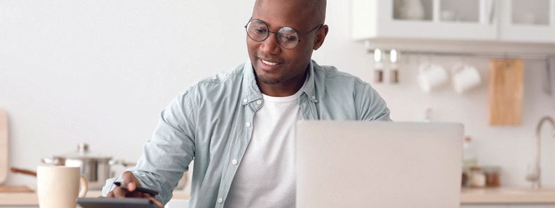 man-at-computer-with-calculator